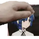a hand is touching a picture of a girl with blue hair and a tie .
