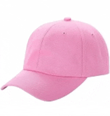 a pink baseball cap is sitting on a white table .