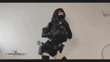 a woman holding a gun with destiny crossplay written on the bottom right