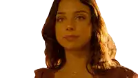 a close up of a woman 's face with a necklace around her neck