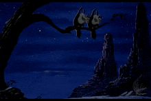 a couple of bats hanging from a tree branch