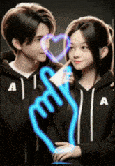 a boy and a girl in black hoodies with the letter a on them