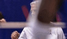 a man wearing a white usa shirt looks at the camera