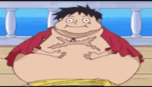 a very fat monkey d luffy from one piece is sitting on a deck .