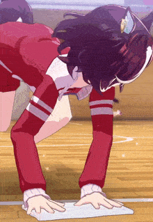 a girl in a red outfit is cleaning the floor with a cloth