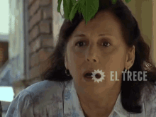 a close up of a woman 's face with el trece written in the corner
