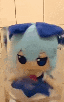 a close up of a stuffed animal with blue hair and blue eyes .