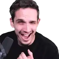 a man is laughing and pointing at the camera