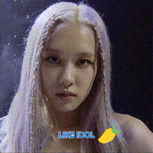 a close up of a woman 's face with the words `` like idol '' written above her .