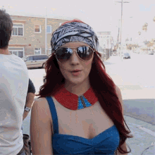 a woman wearing sunglasses and a headband with the letter a on it