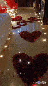 a room decorated with rose petals and balloons with a happy birthday sign on the wall