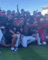 a group of baseball players posing for a picture with a mascot