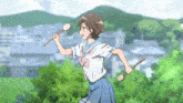 a girl in a school uniform is holding two sticks