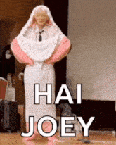a person wrapped in a blanket with the words `` hai joey '' written on the bottom .