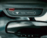 a trunk tobything sticker on the rear view mirror