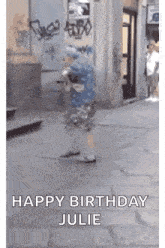 a little girl is walking down a sidewalk with the words `` happy birthday julie '' written on the bottom .