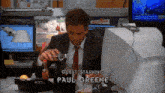 a man in a suit and tie is pouring something into a glass with guest starring paul greene