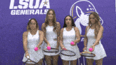 four women holding tennis rackets in front of a lsu generals sign