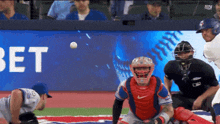 a baseball game is being played in front of a bet banner
