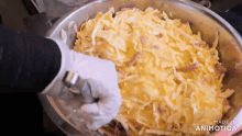 a close up of a person 's hand reaching into a bowl of food