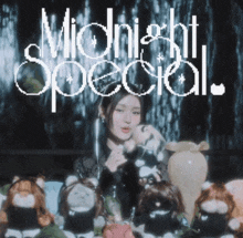 a woman is sitting at a table with stuffed animals and the words midnight special