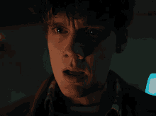 a close up of a man 's face with a tear running down his cheek
