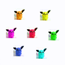 a bunch of colorful stuffed animals are sitting on a table