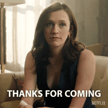 a woman sitting on a couch with the words thanks for coming netflix behind her