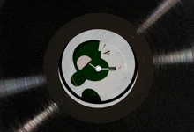a black record with a clock on it that says ccc