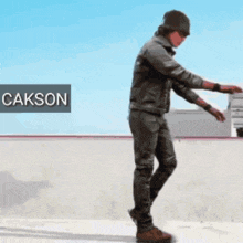 a man standing in front of a sign that says cakson