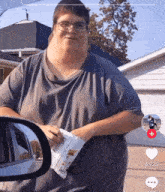 a man with glasses holds a bag of chips in front of a car