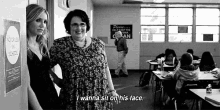 a black and white photo of two women in a classroom with one saying i wanna sit on his face