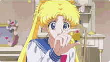 a girl in a sailor suit is covering her eyes with her hand