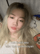 a woman laying on a bed with the words me kahit ano also me ayoko niyan written below her