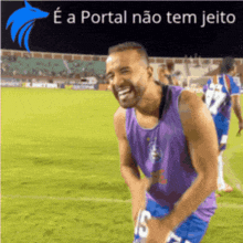 a man in a purple tank top with the number 15 on it is laughing on a soccer field