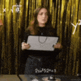 a woman is standing in front of a gold curtain holding a piece of paper that says 2 sin 52 = 1