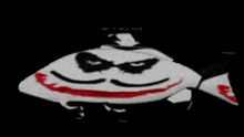 a fish with a joker face painted on it 's body .