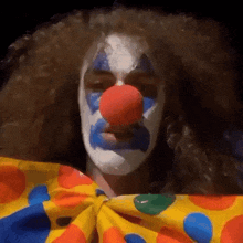 a man dressed as a clown with blue and white face paint