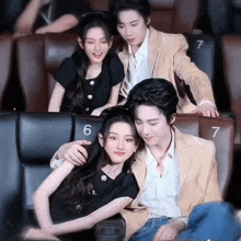 a man and a woman are sitting in a movie theater .