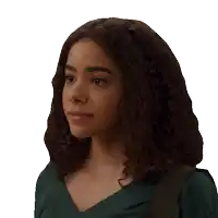a young woman with curly hair wearing a green shirt