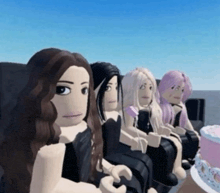 a group of girls are sitting next to each other with a cake in the background