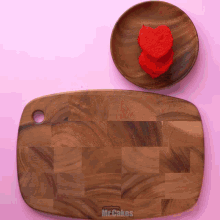 a wooden cutting board with the words mr.cakes on it