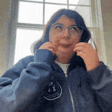 a woman wearing glasses and a jacket that says potatoes on the front