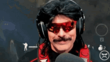 a man with a mustache wearing headphones and red sunglasses