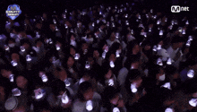 a crowd of people are watching a mnet count down show