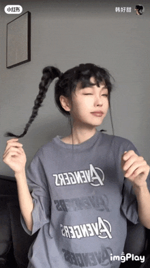 a woman wearing a t-shirt with the letters avengers on it