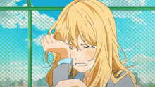 a girl in a suit is crying and covering her face with her hands