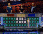 a woman in a white dress is standing in front of a wheel of fortune that says thing