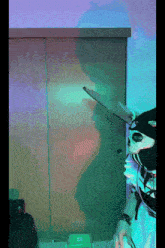 a person wearing a skeleton mask is playing a game on a computer