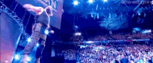 a man is jumping in the air in front of a crowd with a sign that says ' the next big thing '